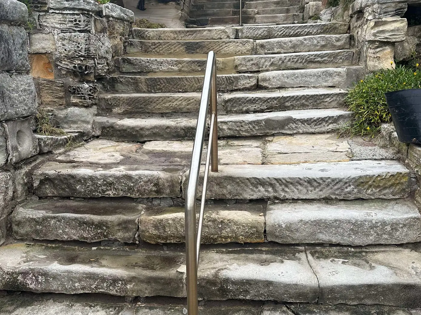 Restored sandstone steps with central handrail