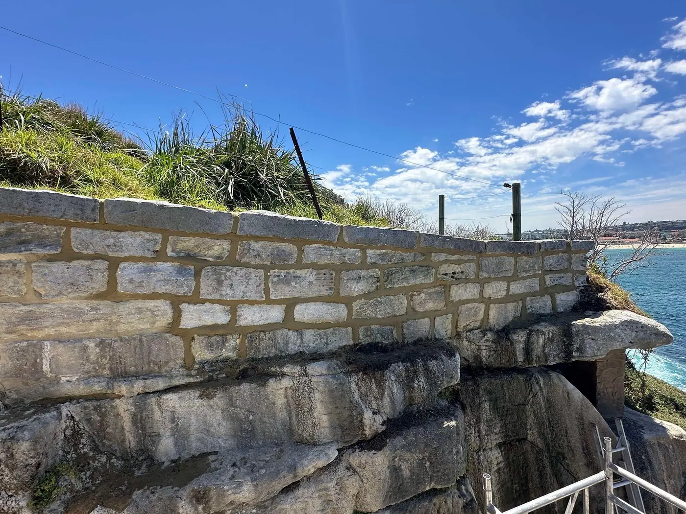 Rebuilt sandstone wall in a coastal landscape